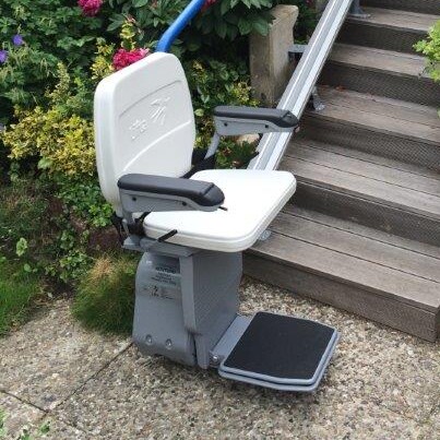 Der Lifta GTL 320 Außenlift an einer geraden Treppe, die vom Garten zur Terrasse führt